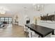 Bright dining room with a chandelier, an adjacent living area, and pool access at 9807 Bay Island Dr, Tampa, FL 33615