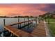 Picturesque evening view of a private dock and waterfront, perfect for boating and relaxing by the water at 9807 Bay Island Dr, Tampa, FL 33615