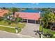Charming waterfront home with a paver driveway, two-car garage, and a red tile roof at 9807 Bay Island Dr, Tampa, FL 33615