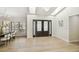 Bright foyer with high ceilings, skylights, and a dining area featuring a modern chandelier and shuttered windows at 9807 Bay Island Dr, Tampa, FL 33615