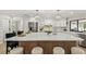 Bright kitchen with a large center island, stainless steel appliances, white cabinets, and modern pendant lighting at 9807 Bay Island Dr, Tampa, FL 33615