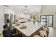 Modern kitchen featuring white cabinets, a center island, modern appliances, and access to the pool at 9807 Bay Island Dr, Tampa, FL 33615