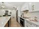 Updated gourmet kitchen with marble backsplash, stainless steel appliances, and a center island at 9807 Bay Island Dr, Tampa, FL 33615