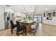 Large kitchen with a quartz island, modern appliances, and bar stool seating overlooking the pool at 9807 Bay Island Dr, Tampa, FL 33615