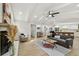Spacious living room featuring vaulted ceilings, a fireplace, and an open layout with bar and kitchen views at 9807 Bay Island Dr, Tampa, FL 33615