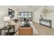 Inviting living room featuring hardwood floors, stylish furniture, modern art, and sliding glass doors to the backyard at 9807 Bay Island Dr, Tampa, FL 33615