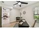 Well-lit office space with a desk, chair, light fixture, wood floors and decorative clock at 9807 Bay Island Dr, Tampa, FL 33615