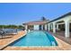 Gorgeous waterfront pool with a brick patio and access to the open bay, perfect for relaxation and entertaining at 9807 Bay Island Dr, Tampa, FL 33615