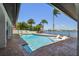 Beautiful waterfront pool with brick pavers and a stunning view of the open bay and clear blue skies at 9807 Bay Island Dr, Tampa, FL 33615
