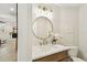Elegant powder room with a marble countertop, modern lighting, and a decorative mirror at 9807 Bay Island Dr, Tampa, FL 33615