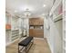 Spacious walk-in closet with custom shelves, drawers, a chandelier, and a full-length mirror at 9807 Bay Island Dr, Tampa, FL 33615