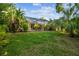 Expansive backyard featuring a screened-in pool and lush landscaping for ultimate privacy at 10418 Applecross Ln, Tampa, FL 33626