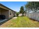 A well-kept backyard featuring a lush lawn and a privacy fence, providing a secure and serene outdoor space at 11638 Palmetto Pine St, Riverview, FL 33569