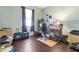 Bedroom with wood floors, a window, desk, and overflowing with unpacked boxes at 11638 Palmetto Pine St, Riverview, FL 33569