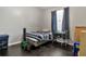 Bedroom with hardwood floors, gray walls, and a window with navy curtains at 11638 Palmetto Pine St, Riverview, FL 33569