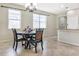 Bright dining room with decorative chandelier, window blinds, and a four-chair dining set at 11638 Palmetto Pine St, Riverview, FL 33569