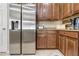 Modern kitchen featuring stainless steel refrigerator and dark wood cabinets at 11638 Palmetto Pine St, Riverview, FL 33569
