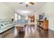 Living room features a ceiling fan, hardwood floors, and an open floor plan into the kitchen at 11638 Palmetto Pine St, Riverview, FL 33569