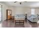 Comfortable living room with hardwood floors, couches, and cabinet at 11638 Palmetto Pine St, Riverview, FL 33569