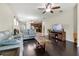 Open living room with hardwood floors, ceiling fan, and an adjacent kitchen area at 11638 Palmetto Pine St, Riverview, FL 33569