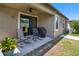 A cozy patio with rocking chairs, seamlessly accessible from inside, ideal for outdoor dining and leisure at 11638 Palmetto Pine St, Riverview, FL 33569