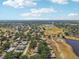 Expansive aerial shot showcases a residential area near a golf course and pond, highlighting the serene environment at 1218 Haddington Cir, Sun City Center, FL 33573