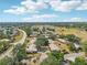 Sprawling neighborhood featuring cozy villas, a golf course, and an adjacent pond with a fountain at 1218 Haddington Cir, Sun City Center, FL 33573