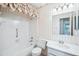 Classic bathroom featuring a white tub, toilet, vanity, and striped wallpaper at 1218 Haddington Cir, Sun City Center, FL 33573