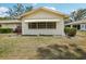 Home exterior with a large window and a well-maintained lawn and landscaping at 1218 Haddington Cir, Sun City Center, FL 33573