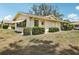 Home exterior featuring a well-manicured lawn and a view of the side of the house at 1218 Haddington Cir, Sun City Center, FL 33573