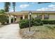 Charming home featuring well-maintained landscaping and a covered parking area at 1218 Haddington Cir, Sun City Center, FL 33573