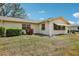 Cozy home exterior featuring a well-maintained lawn and lush landscaping, creating a welcoming curb appeal at 1218 Haddington Cir, Sun City Center, FL 33573
