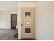 Close-up of the front door with decorative details and adjacent screen door at 1218 Haddington Cir, Sun City Center, FL 33573
