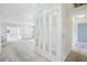 Bright hallway with mirrors, leading to carpeted living spaces and bedrooms at 1218 Haddington Cir, Sun City Center, FL 33573