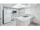 Bright kitchen features white cabinets, modern appliances, and skylight at 1218 Haddington Cir, Sun City Center, FL 33573