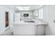 Efficient kitchen with a white appliances and light countertops, illuminated by a skylight at 1218 Haddington Cir, Sun City Center, FL 33573