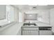 Open kitchen with white countertops, modern appliances, and a view of the living room at 1218 Haddington Cir, Sun City Center, FL 33573