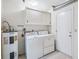 Functional laundry room with a washer, dryer, and water heater at 1218 Haddington Cir, Sun City Center, FL 33573