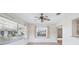 Bright living room with large windows, ceiling fan, and easy access to other rooms at 1218 Haddington Cir, Sun City Center, FL 33573
