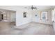 Open-concept living room with neutral walls, adjoining kitchen and outdoor access at 1218 Haddington Cir, Sun City Center, FL 33573
