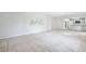 Spacious living room with chandelier, neutral carpet, and an open view to the kitchen at 1218 Haddington Cir, Sun City Center, FL 33573