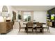 Bright dining room with table set for four, sideboard and view of living room at 12751 Crystal Jade Way, Parrish, FL 34219