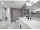 Modern bathroom with zebra-print wallpaper, marble countertops, and stylish fixtures at 14810 Rue De Bayonne # 2D, Clearwater, FL 33762