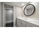 Modern bathroom with a vanity with a white marble countertop, shower, and black herringbone tile floor at 14810 Rue De Bayonne # 2D, Clearwater, FL 33762