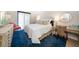Comfortable bedroom with natural light, a decorative chair, and a stylish desk area at 14810 Rue De Bayonne # 2D, Clearwater, FL 33762
