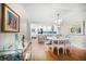 Bright dining area with a modern chandelier, adjacent to an open kitchen and stylish bar cart at 14810 Rue De Bayonne # 2D, Clearwater, FL 33762