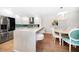 Open-concept kitchen with white cabinets, breakfast bar, stainless steel appliances, and adjacent dining area at 14810 Rue De Bayonne # 2D, Clearwater, FL 33762