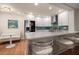 Inviting kitchen features white cabinets, stainless steel appliances, and cozy breakfast seating area at 14810 Rue De Bayonne # 2D, Clearwater, FL 33762