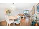 Bright living room features a dining area and natural light streaming through large windows with an outdoor view at 14810 Rue De Bayonne # 2D, Clearwater, FL 33762