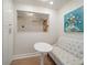 Cozy seating area nook featuring seating with white fabric and a small modern table at 14810 Rue De Bayonne # 2D, Clearwater, FL 33762